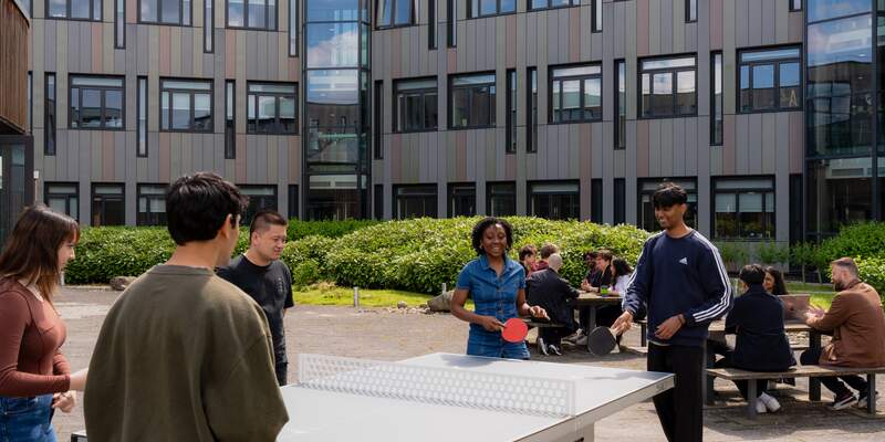 students playing table tennis near the computer science building